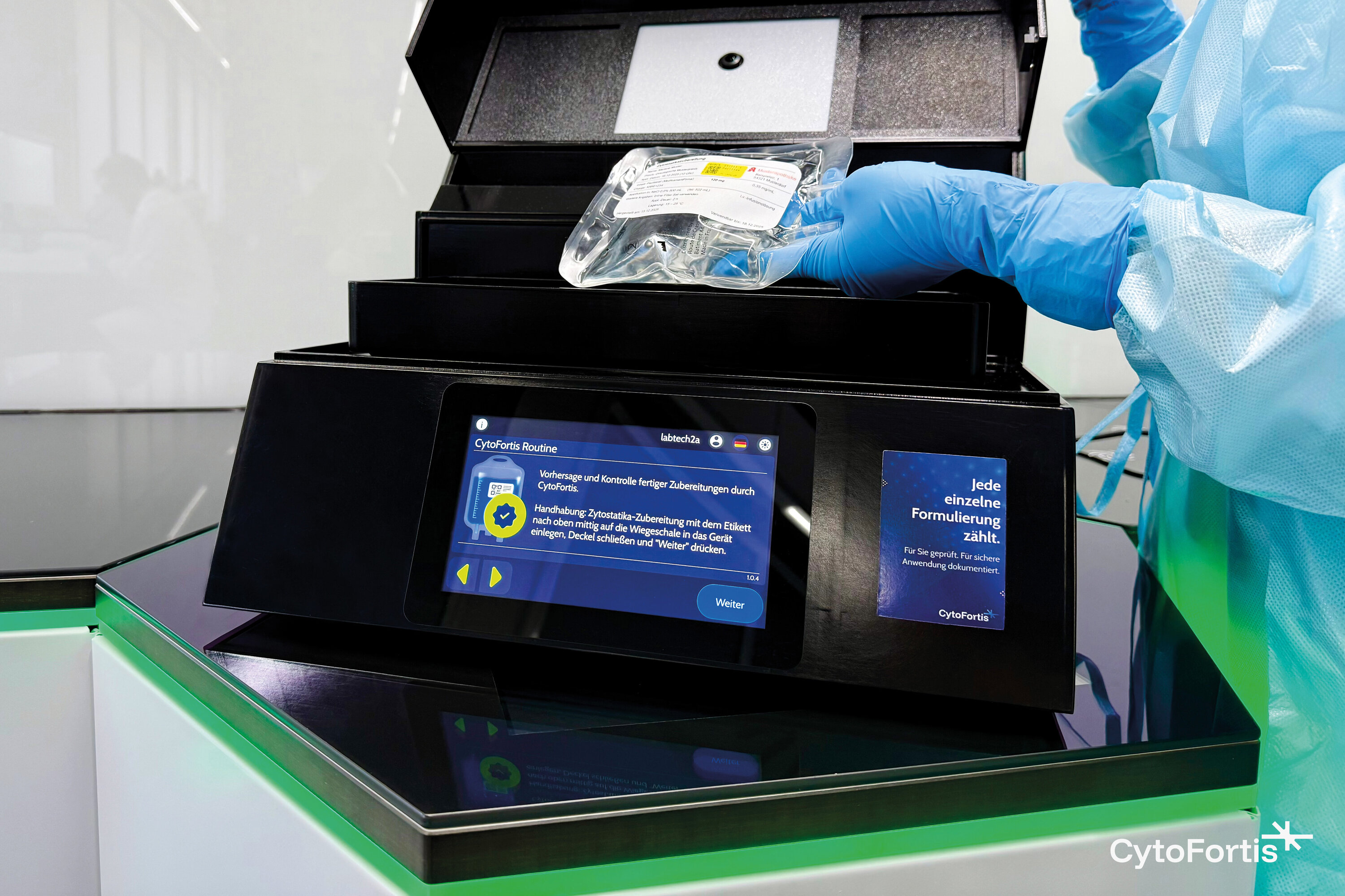 Person in a laboratory places a cytostatic bag into the CytoFortis device